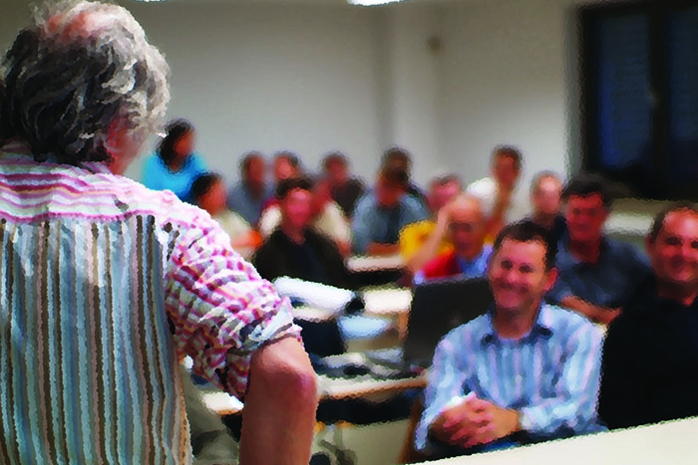 Group listening to instructor in a classroom setting