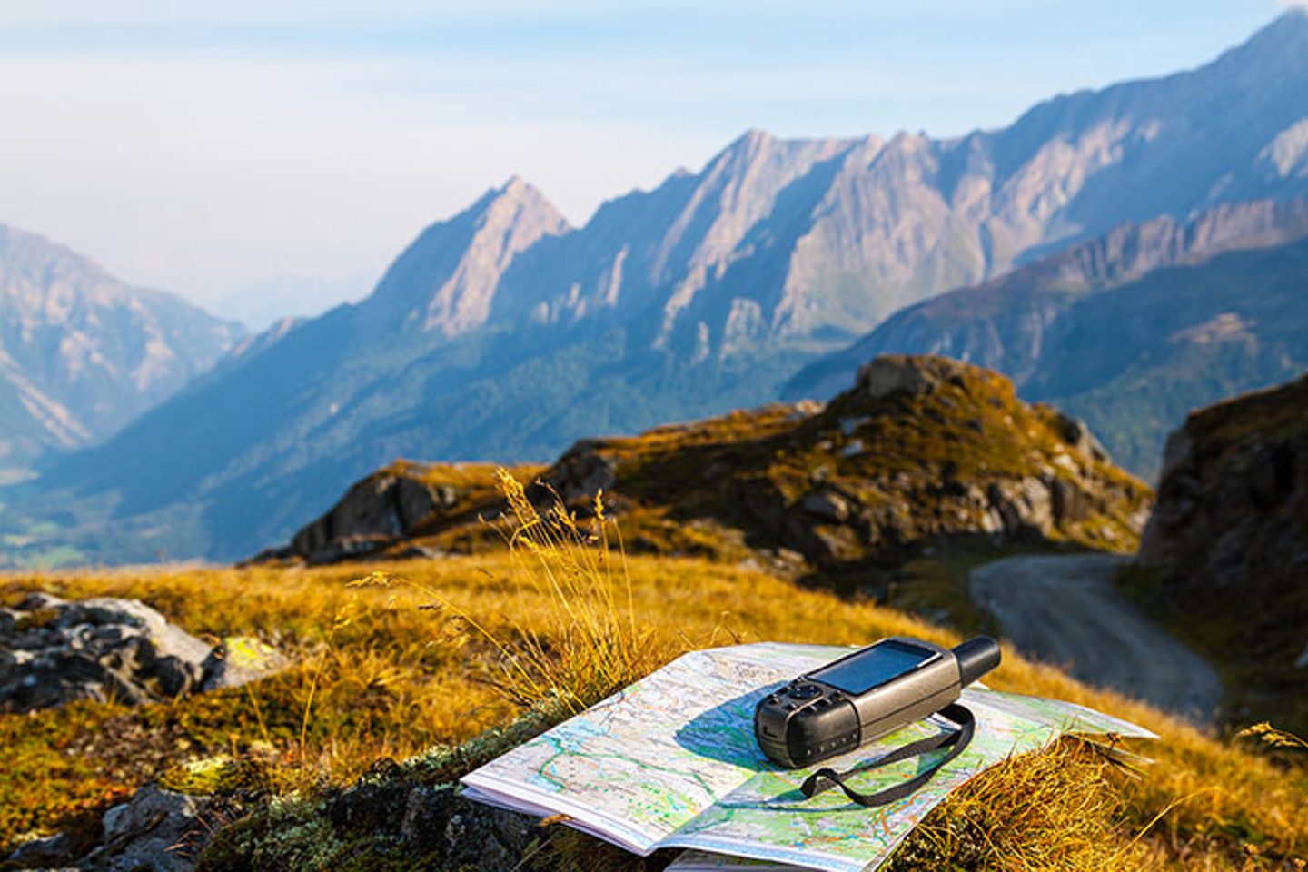 Mountain view with map and GPS device in foreground